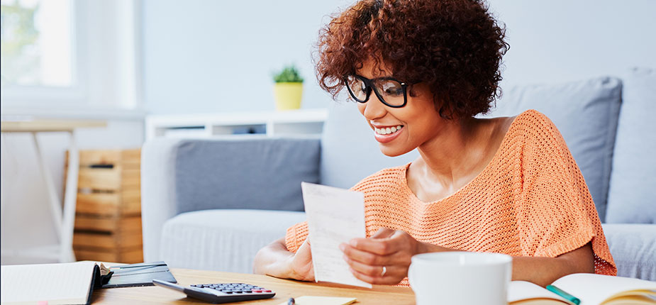 happy smiling woman looking at energy bill